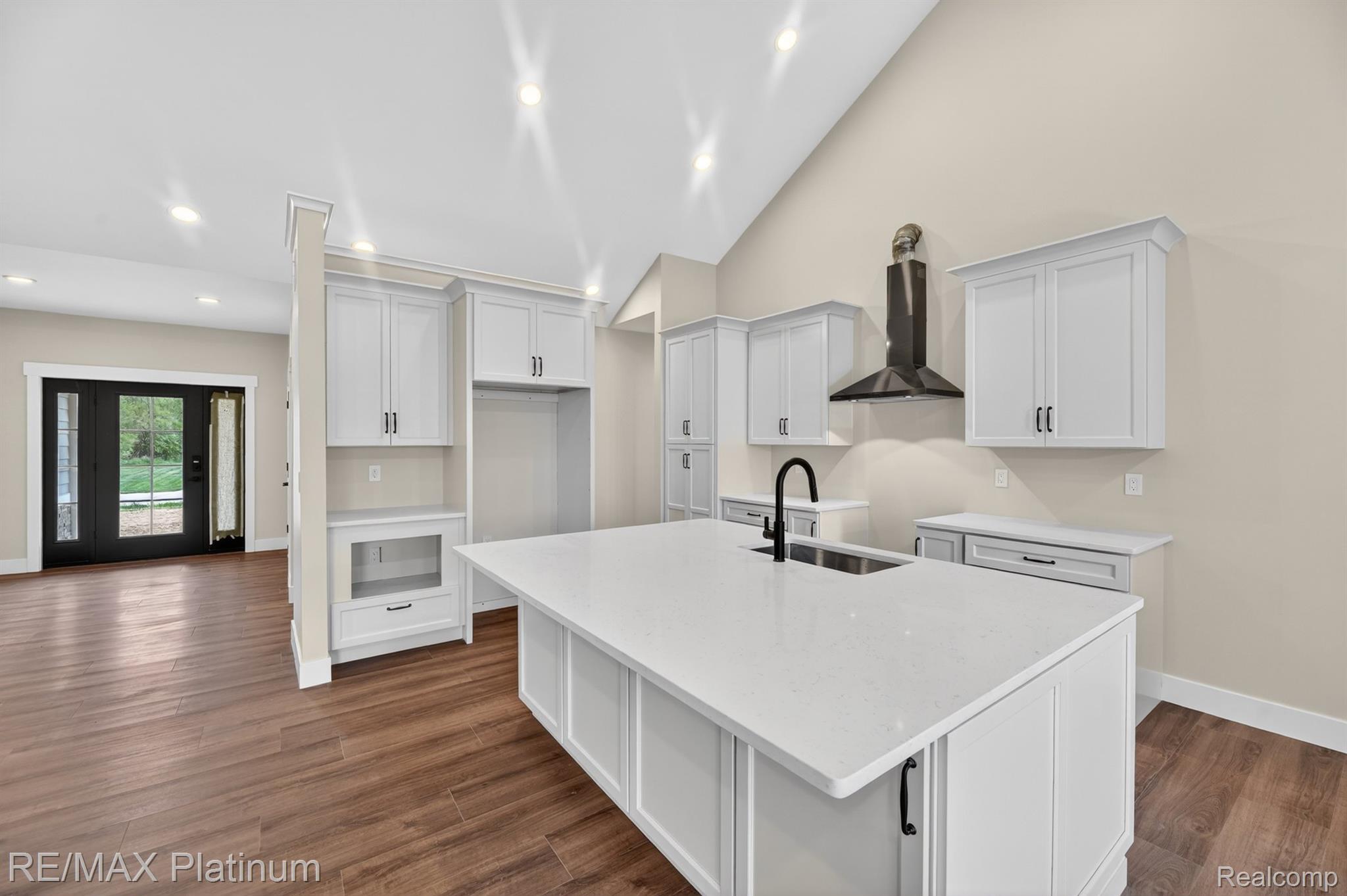 Kitchen with white cabinetry and island