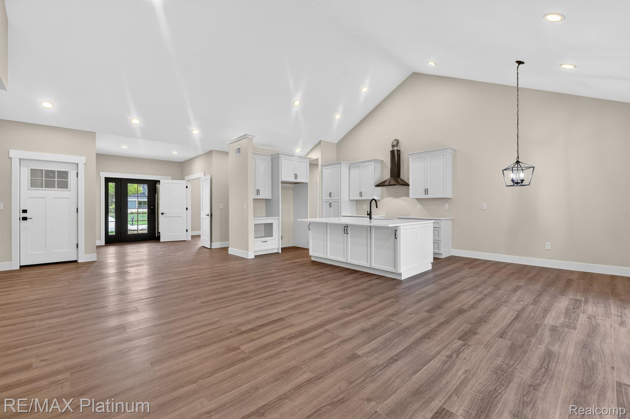 Open living and dining area with cathedral ceiling